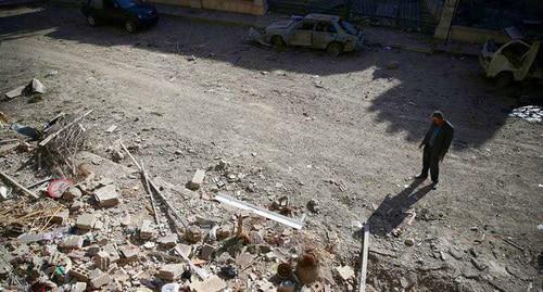 A man is looking at the ruins of the building. Damascus, Syria. Photo REUTERS/Bassam Khabieh