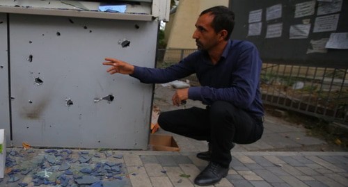 Resident of a village in Azerbaijan shows traces from shelling attacks. Photo by Aziz Karimov for the Caucasian Knot