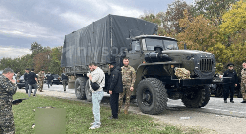 Law enforcer at the car after shelling. Screenshot of the photo posted on the Telegram channel RusNews on October 24, 2024 https://t.me/rusnews/61330