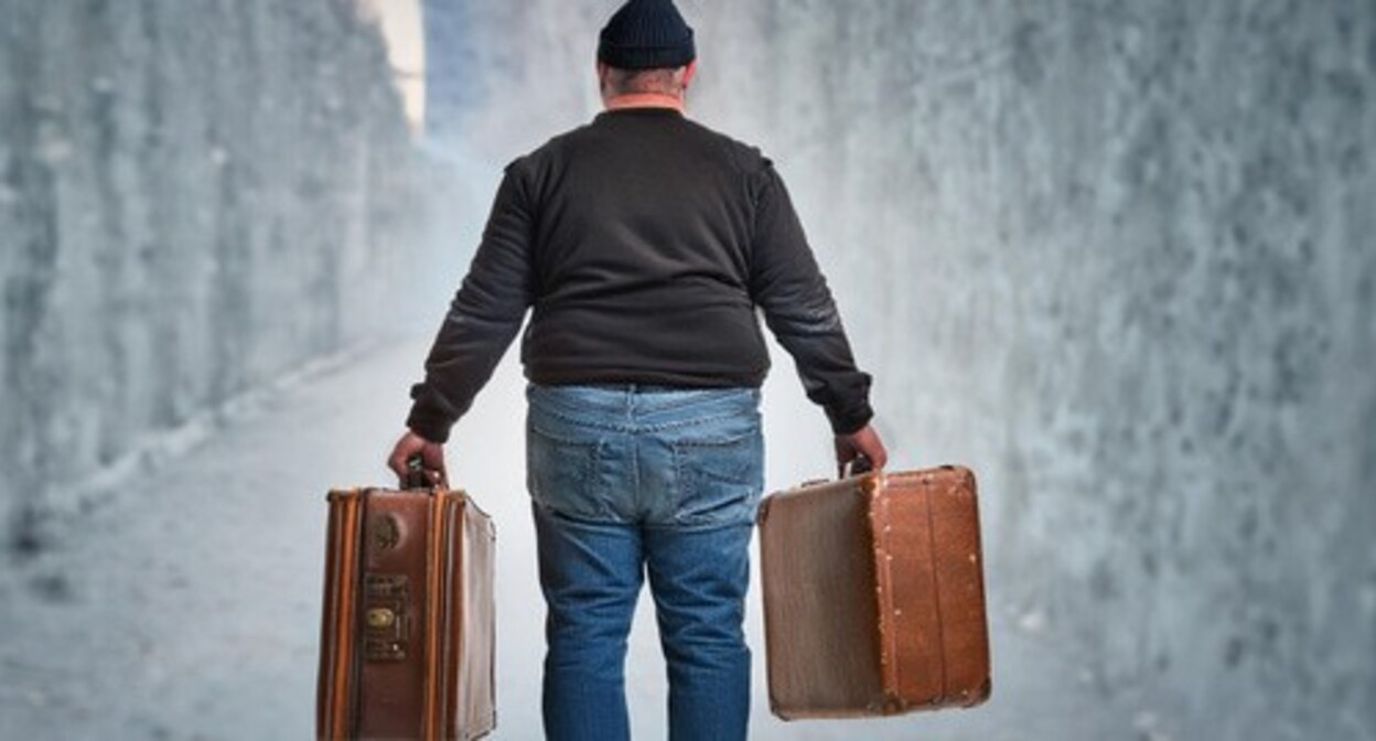 A man carrying suitcases. Picture made by Photoshop