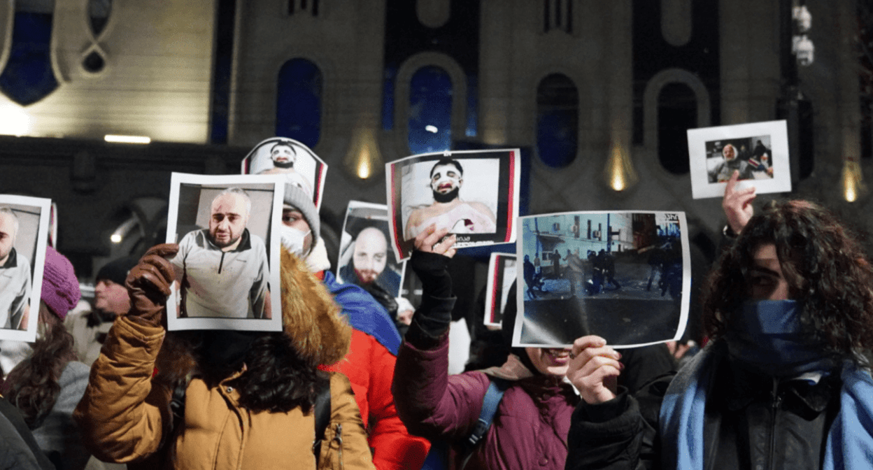 Protesters at the Georgian Parliament with photos of people beaten during the dispersal of protests. Screenshot of a photo posted on the Facebook page (the activities of the Meta Company, owning Facebook, are banned in Russia) of Publika on December 14, 2024 https://www.facebook.com/photo?fbid=1323468535719360&amp;set=pcb.1323472962385584