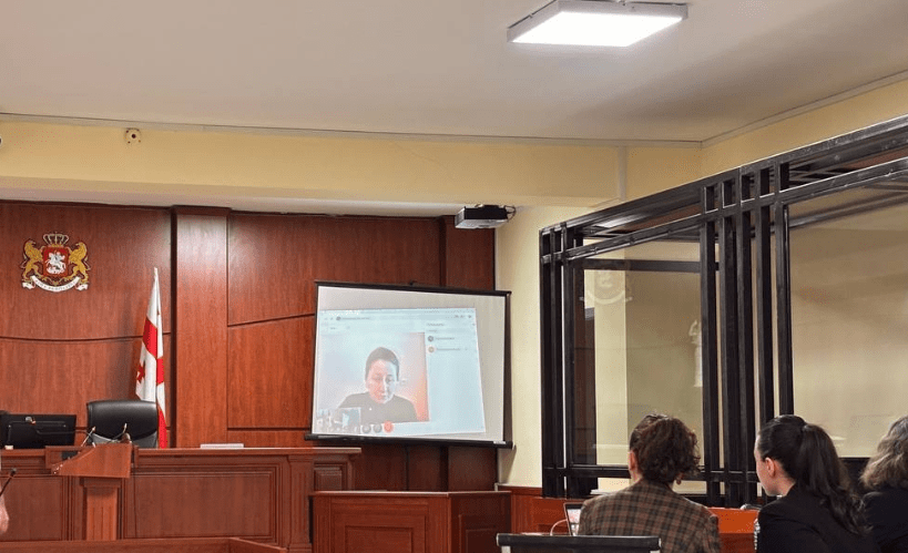 Mziya Amaglobeli speaks in a court via videoconferencing. Screenshot of a photo posted by the “Netgazeti” on March 13, 2025 https://ru.netgazeti.ge/67603/ Mziya Amaglobeli speaks in a court via videoconferencing. Screenshot of a photo posted by the “Netgazeti” on March 13, 2025 https://ru.netgazeti.ge/67603/