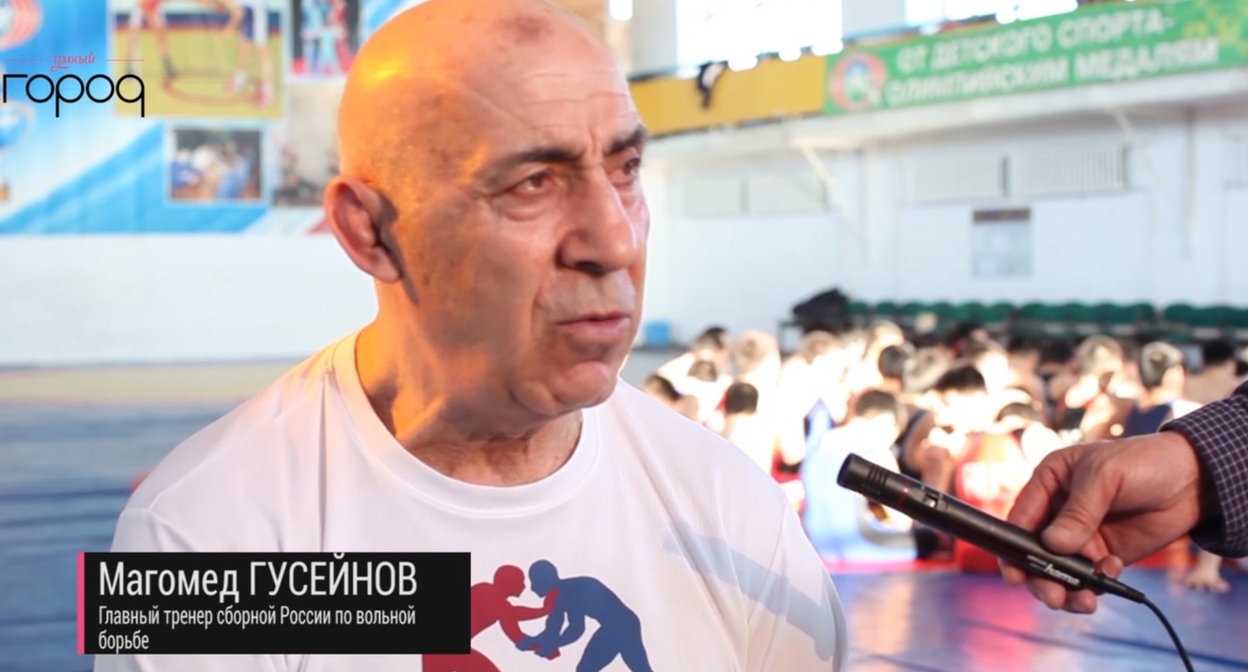 Magomed Guseinov in front of child athletes. 2015. Still from rutube_account_media_sakha https://rutube.ru/video/31726d8b0be014af3f44928d4ad20516/ Magomed Guseinov in front of child athletes. 2015. Still from rutube_account_media_sakha https://rutube.ru/video/31726d8b0be014af3f44928d4ad20516/